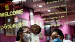 Therapists wearing face shields wait for costumers at a traditional Thai massage shop which reopened after the Thai government eased isolation measures to prevent the spread of the coronavirus disease (COVID-19) in Bangkok, Thailand, June 3, 2020. REUTERS