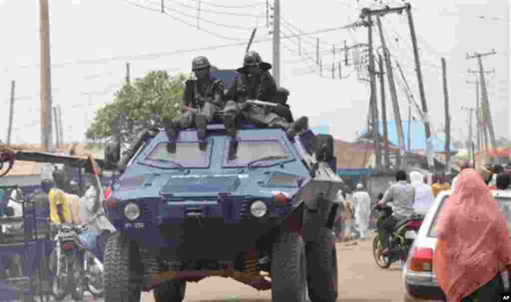 Policeman patrol the street during gubernatorial elections, in Kaduna, Nigeria, Thursday, April 28, 2011. Small crowds of voters nervously cast ballots Thursday in two states in oil-rich Nigeria hit hard by religious rioting that killed at least 500 peop