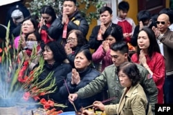 People pray at the Quan Su Pagoda in Hanoi on Jan. 29, 2025, the Lunar New Year, known in Vietnam as Tet.