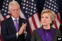 Former President Bill Clinton applauds as his wife, Democratic presidential candidate Hillary Clinton speaks in New York where she conceded her defeat to Republican Donald Trump after the hard-fought presidential election, Nov. 9, 2016.