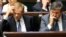 Polish Prime Minister Donald Tusk, left, and Deputy Prime Minister Janusz Piechocinski listen to lawmakers in the parliament in Warsaw, Poland, June 25, 2014. 