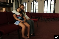 Nury Chavarria, 43, poses with her 9-year-old daughter, Hayley inside Iglesia De Dios Pentecostal church in New Haven, Connecticut, on July 24, 2017. Chavarria has sought sanctuary from deportation because she needs to be with her four children.