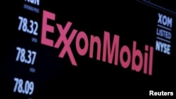 FILE - The logo of Exxon Mobil Corp. is shown on a monitor above the floor of the New York Stock Exchange in New York, Dec. 30, 2015. 