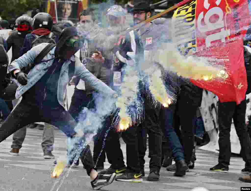 Protesters clash with riot police during a demonstration against labor law reforms in Paris, France.