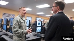 U.S. Defense Secretary Ashton Carter, right, is briefed on the capabilities of the National Guard Cyber Unit at Joint base Lewis-McChord, Washington, March 4, 2016. Carter said the Guard will play an increasingly important role in assessing U.S. vulnerabi