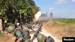 Malaysian soldiers fire toward Kampung Tanduo, where troops stormed the camp of an armed Filipino group, in Lahad Datu, Sabah state on the island of Borneo, Mar. 8, 2013 in this picture provided by Malaysia's Ministry of Defense. 