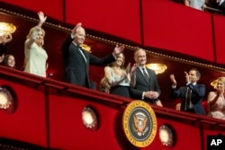 President Joe Biden, 2nd from left, First Lady Jill Biden, left, wave to the crowd next to Vice President Kamala Harris, center, and Second Gentleman Doug Emhoff at the start of the Kennedy Center Honors Gala, Dec. 8, 2024, in Washington.