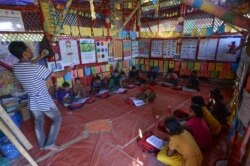 Rohingya children attend a lesson to learn their language at a school at Jamtola refugee camp in Ukhia on Dec. 9, 2019.