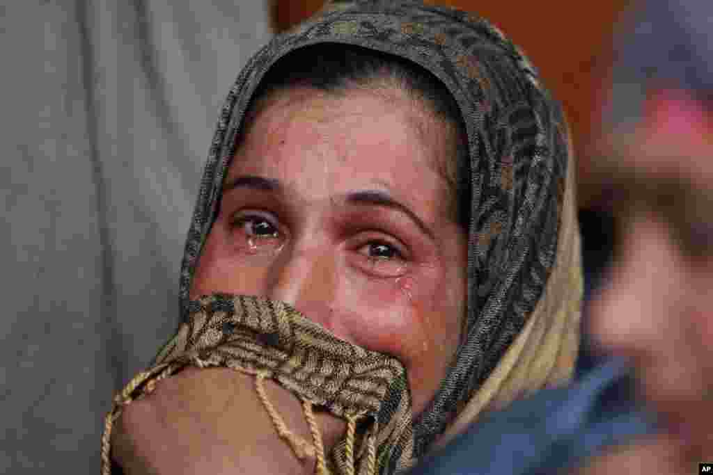 A relative of Abdul Ghani Mir, who was killed in the cross fire between government forces and rebels, cries during his funeral at Pinglan some 38 kilometers (23.75 miles) south of Srinagar, Indian-controlled Kashmir.