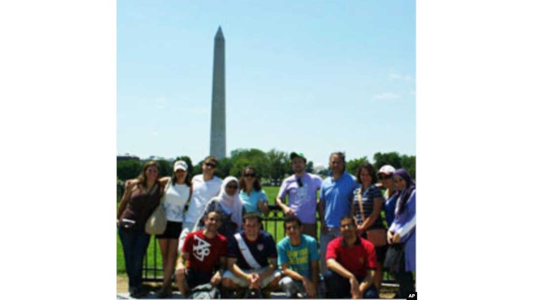 A team of LearnServeEgypt Program participants standing in front of the Washington Monument in the US capital