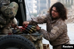FILE - A Free Syrian Army fighter handles ammunition in a rebel-held area of Aleppo, Syria, Dec. 12, 2016.