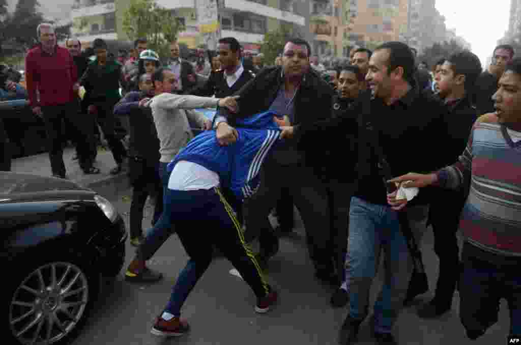 Egyptian police arrest a Muslim Brotherhood supporter (C) following a demonstration in the Nasr City district of Cairo.