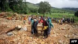 Men carry a coffin on along a makeshift path on the river in Ngangu township Chimanimani, Manicaland Province, eastern Zimbabwe, after the area was hit by the cyclone Idai.