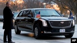 A presidential limo known as "The Beast" carrying President Donald Trump and first lady Melania Trump arrives outside Blair House across the street from the White House in Washington, Dec. 4, 2018.