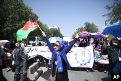 Thousands of demonstrators march towards the center of Kabul, Afghanistan, Saturday, July 23, 2016.