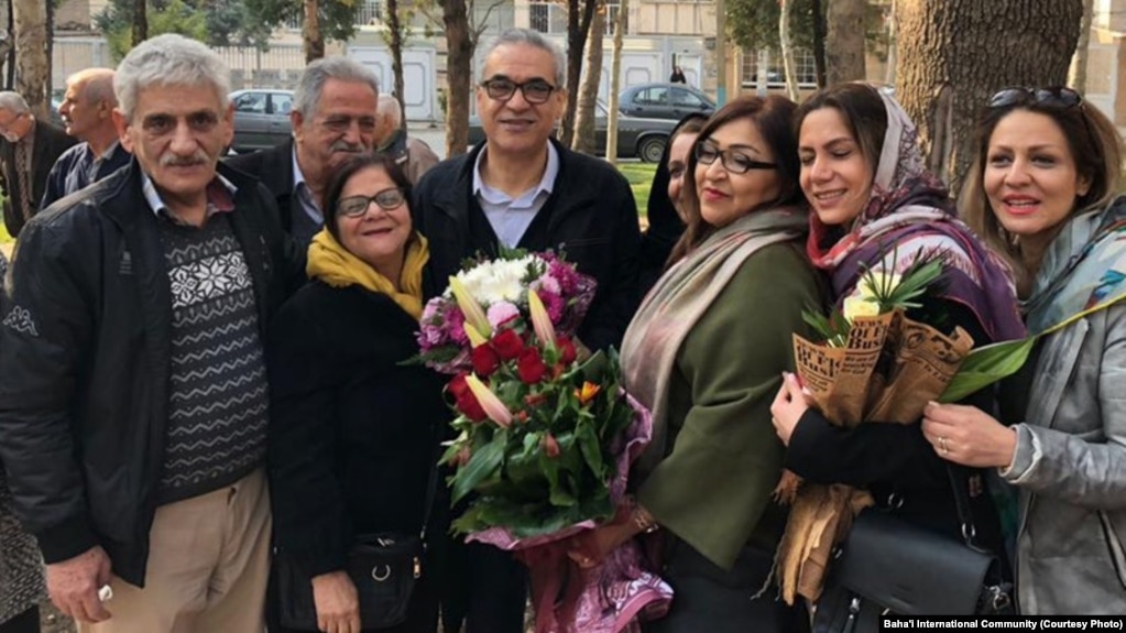 Afif Naeimi, a former leader of Iran's Baha'i community, is greeted by his wife and other loved ones following his Dec. 20, 2018, release from a decade of detention at Tehran's Evin prison.