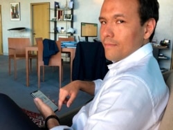 French Digital Affairs junior minister Cedric O demonstrates how to use the French app StopCovid meant to trace the virus' future spread on during an interview with the Associated Press in Paris, Friday, May 29, 2020.