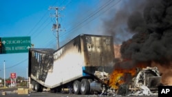 ARCHIVO - Un camión arde en una calle de Culiacán, estado de Sinaloa, México, el 5 de enero de 2023, después de que las fuerzas de seguridad mexicanas capturaran a Ovidio Guzmán, hijo del exjefe del cártel de Sinaloa, Joaquín "El Chapo" Guzmán. 