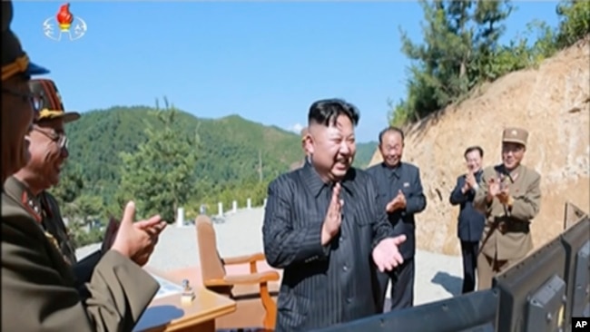 This image made from video of a news bulletin aired by North Korea's KRT on Tuesday, July 4, 2017, shows what was said to be North Korea leader Kim Jung Un, center, applauding after the launch of a Hwasong-14 intercontinental ballistic missile, ICBM, in N