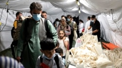 Evacuated citizens from Afghanistan arrive at Tirana International Airport in Tirana, Albania, Friday, Aug. 27, 2021. Albania agreed to host Afghan refugees while they are being vetted for visas for the US.