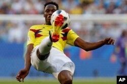 Colombia's Yerry Mina kicks during a match with Senegal in Samara, Russia, June 28. Colombia's team jersey goes for bold color. (AP)