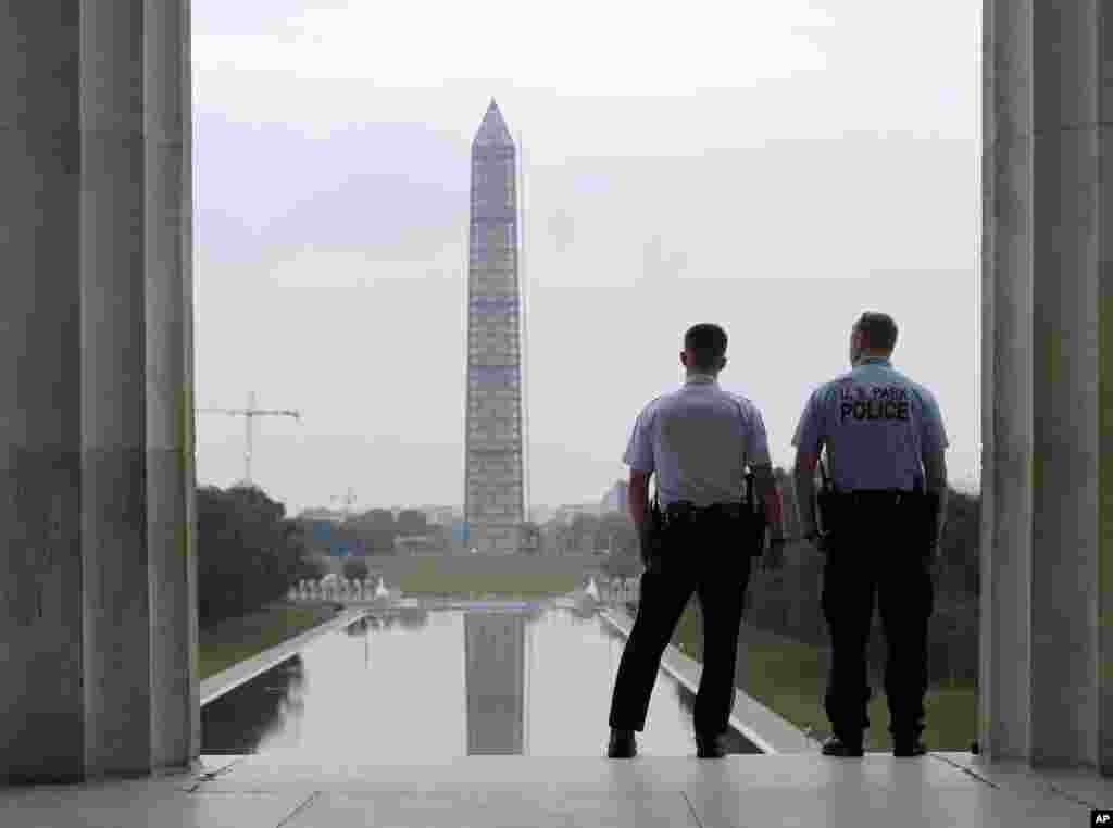 With the Washington Monument in the distance, Park Service police officers stand on duty at the Lincoln Memorial in Washington, Oct. 17, 2013.