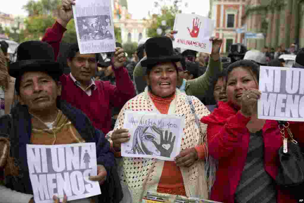 Aymara women and activists shout slogans and hold signs that read in Spanish "not one less" during a march against gender violence in La Paz, Bolivia, Oct. 19, 2016. Similar protests were made throughout Latin America after a teen was slain in Argentina.