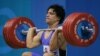 FILE - Shahin Nasirinia of Iran lifts in the clean and jerk during the men's 207 lb (94 kg) event at the Nikaia Olympic Weightlifting Hall during the Summer Olympics in Athens, Monday Aug. 23, 2004.