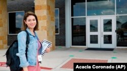 First-year teacher Cindy Hipps stands outside of Lagos Elementary School, at Manor Independent School District campus east of Austin, Texas
(Acacia Coronado/Report for America via AP)