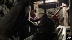 Miners work inside a mine for the blue-green gemstone known as larimar in Las Filipinas, Barahona province, Dominican Republic, March 18, 2015.