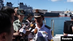 Zhao Xiaogang, drill director of the Chinese fleet participating in the RIMPAC multinational military exercise, joins in a news conference at Joint Base Pearl Harbor Hickam in Honolulu, Hawaii June 30, 2014.