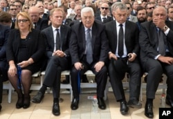 Palestinian President Mahmoud Abbas, center, sits next to European Council President Donald Tusk, second left, during the funeral of former Israeli President Shimon Peres at Mt. Herzl Military Cemetery in Jerusalem, Sept. 30, 2016.