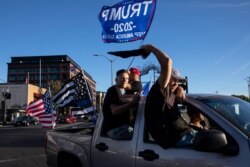 Supporters of President Donald Trump attend a rally and car parade, Aug. 29, 2020, in Clackamas, Ore., on the way to Portland.