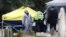Members of the emergency services in protective suits work at the site of the grave of Liudmila Skripal, wife of former Russian intelligence officer Sergei Skripal, at London Road Cemetery, in Salisbury, Britain, March 10, 2018.