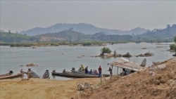 Local villagers travel on the Mekong River near Nong Khai, Thailand. The river’s water has become clear since the Xayaburi dam upstream began generating hydropower. (Steve Sandford/VOA)