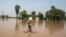 Flood victim stands in flood waters following heavy rain in Jhang, Punjab province, Sept. 11, 2014.