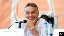 Hungarian Prime Minister Viktor Orban smiles as he is introduced before delivering a speech at the Balvanyos Summer University and Students' Camp in Baile Tusnad, Romania, July 25, 2015.