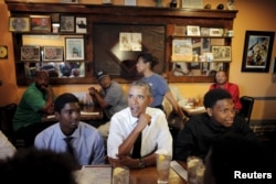 President Barack Obama sits for lunch at Willie Mae's restaurant near downtown during a presidential visit to New Orleans, Aug. 27, 2015.