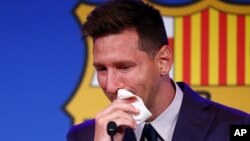 Lionel Messi cries at the start of a press conference at the Camp Nou stadium in Barcelona, Spain, Aug. 8, 2021.