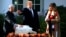 President Donald Trump with first lady Melania Trump, right, gives "Peas", on of the National Thanksgiving Turkeys, an absolute pardon during a ceremony in the Rose Garden of the White House, in Washington, Nov. 20, 2018. 