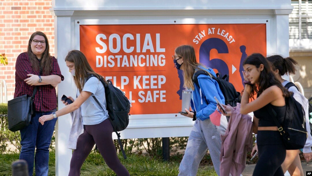 University of Illinois student Sarah Keeley, left, poses for a portrait on the college campus in Urbana, Ill., Tuesday, Oct. 6, 2020. (AP Photo/Charles Rex Arbogast)