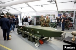 FILE - Army personnel look at a Taurus cruise missile at the International Aerospace Exhibition ILA on the opening day at Schoenefeld Airport in Berlin, Germany, June 5, 2024.