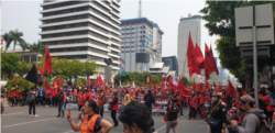 Buruh dari Kongres Aliansi Serikat Buruh Indonesia saat aksi di jalan Thamrin, Jakarta menolak RUU Ketenagakerjaan dan UU KPK, Senin, 28 Oktober 2019. (Foto: Sasmito Madrim/VOA)