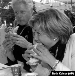 President Clinton, left, and first lady Hillary Rodham Clinton enjoy sausages at Gianelli's stand at the New York State Fair in Syracuse, N.Y., Sept. 2, 2000.