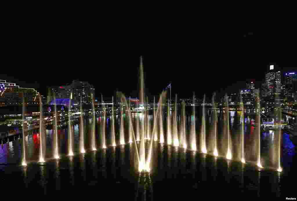 Water fountains are lit up as part of the Aquatique Show International, one night before the Vivid Festival&#39;s opening at Darling Harbor in Sydney, Australia.