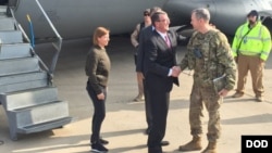 FILE - U.S. Defense Secretary Ash Carter greets Army Lt. Gen. Sean MacFarland after arriving in Baghdad, Dec. 16, 2015. Carter is on a weeklong trip to the Middle East. 