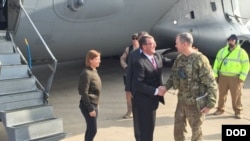 FILE - Army Lt. Gen. Sean MacFarland greets U.S. Defense Secretary Ash Carter after arriving in Baghdad, Dec. 16, 2015. MacFarland says end of IS is ‘a matter of time’ and more help."