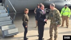 U.S. Defense Secretary Ash Carter greets Army Lt. Gen. Sean MacFarland after arriving in Baghdad, Dec. 16, 2015. Carter is on a weeklong trip to the Middle East. 