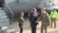 FILE - Army Lt. Gen. Sean MacFarland greets U.S. Defense Secretary Ash Carter after arriving in Baghdad, Dec. 16, 2015. MacFarland says end of IS is ‘a matter of time’ and more help."