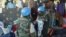 FILE - U.N. peacekeeper soldiers hold a baby as South Sudanese people seek protection at the U.N. camp in Juba, South Sudan, July 14, 2016.